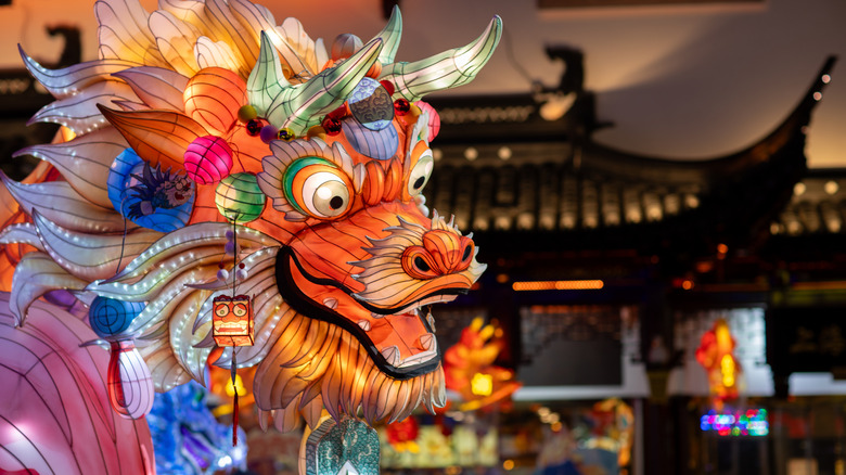 A colorful Chinese dragon with a temple in the background.