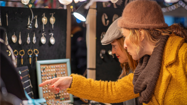 Two women shopping for jewelry at a Christmas market