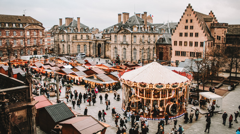 Christmas market at Strasbourg, with stalls and a carrousel the city's plaza