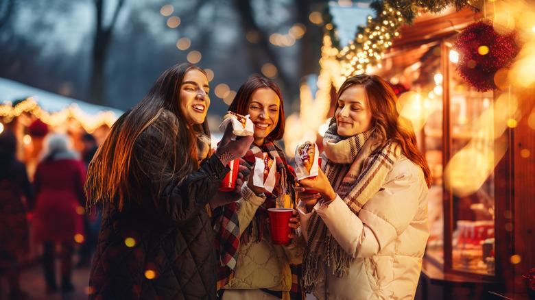 Women enjoying good and hot drinks at a Christmas market