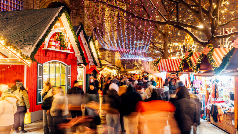 Bustling Christmas market in Berlin with wooden stalls and bright lights