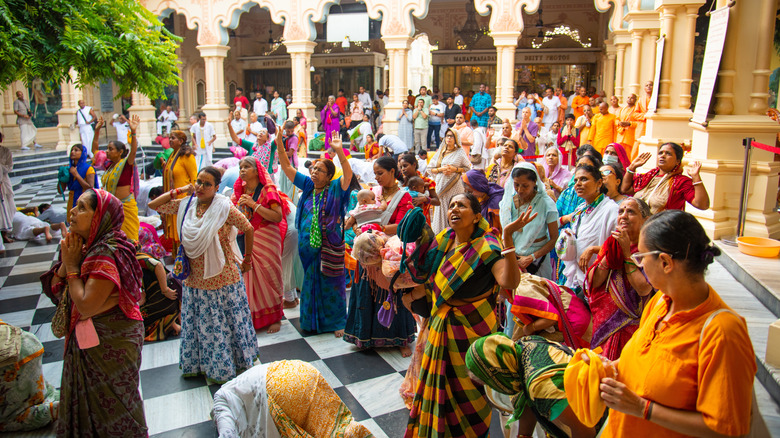 Worshippers during kirtan at Krishna Balarama temple