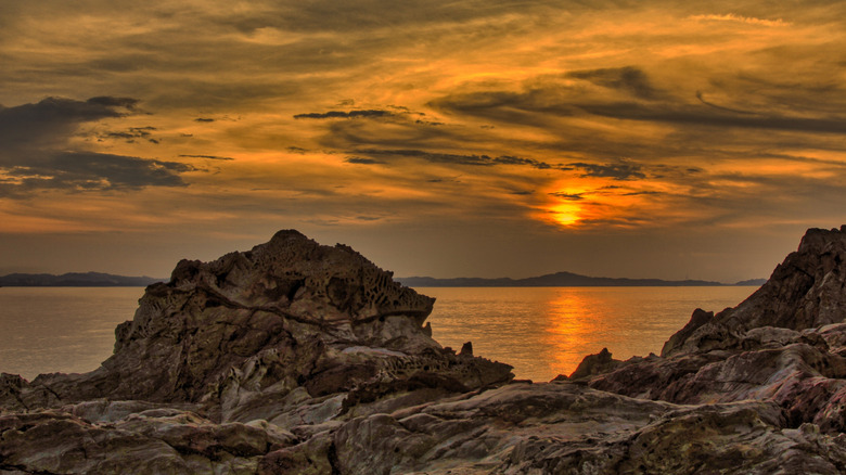 A rocky beach on Pulau Kapas at sunset.