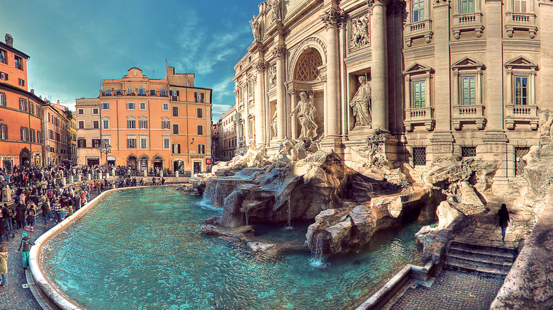 Trevi fountain and piazza in evening with crowds