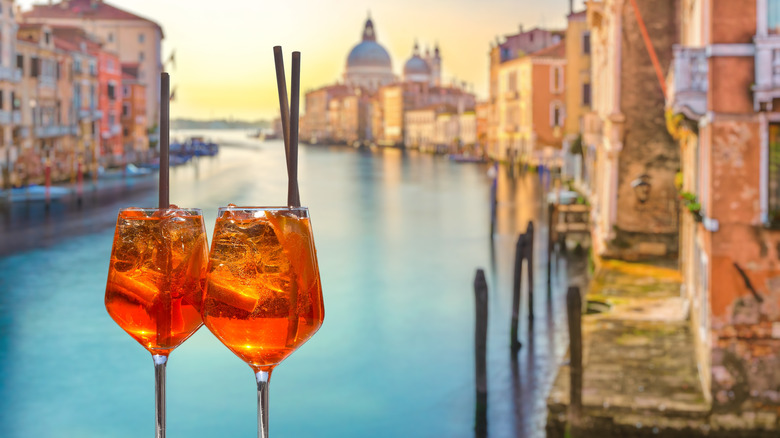 Two aperol spritz drinks on the grand canal