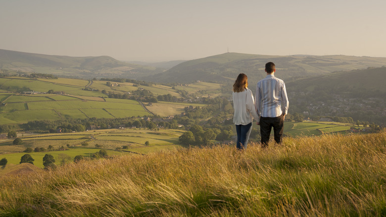 Couple looking out from top of hill