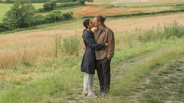 Couple kissing in a field