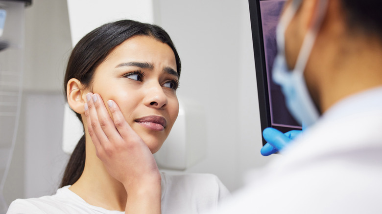 Woman with toothache on vacation