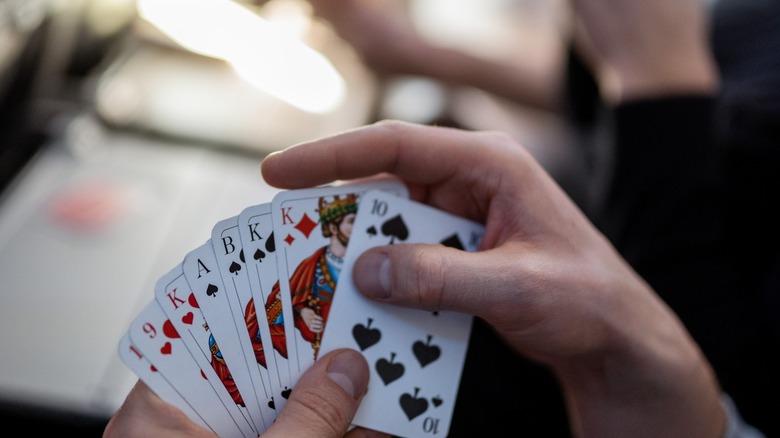 Someone playing cards on an airplane