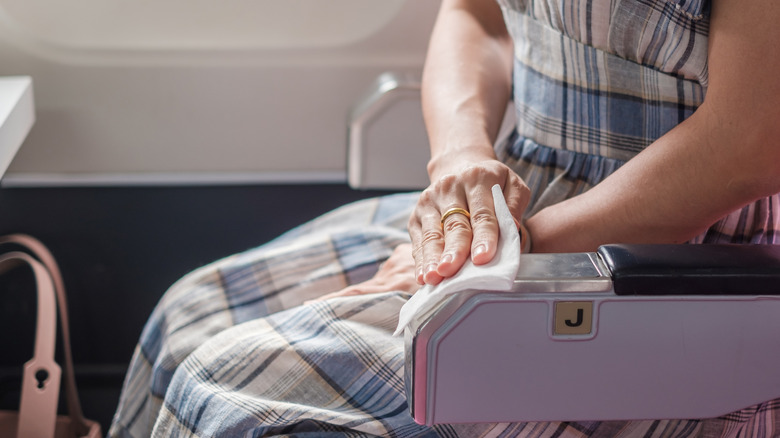 Woman cleaning seat with wet wipes