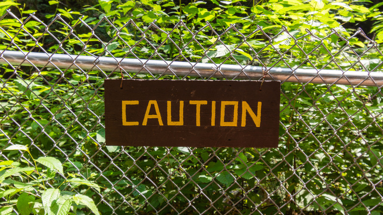 A caution sign on a mesh fence in Madame Sherri Forest, New Hampshire.