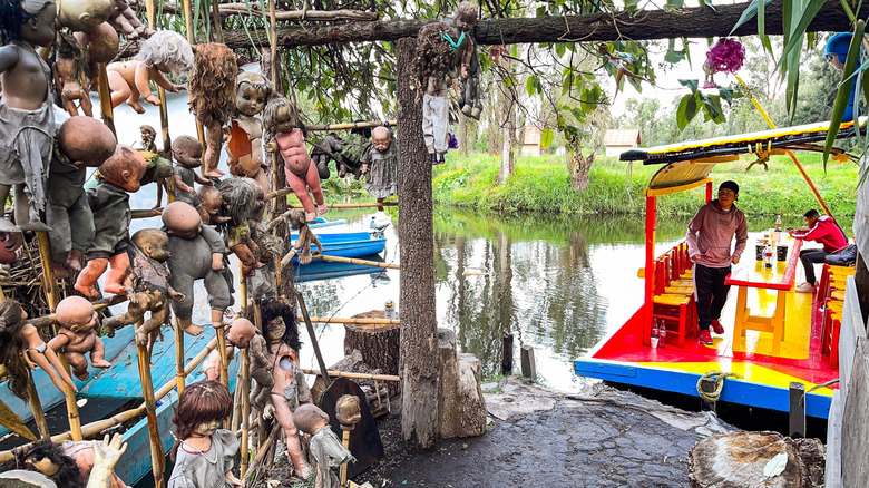 A boat arriving at the Island of the Dolls in Mexico.