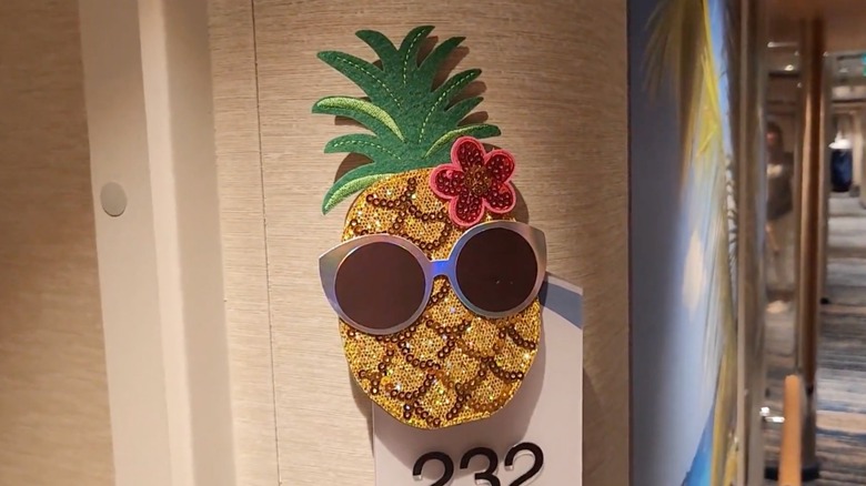 A pineapple on a cruise ship door