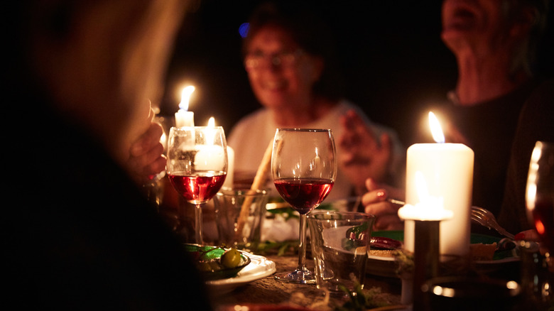 People sharing candlelit dinner