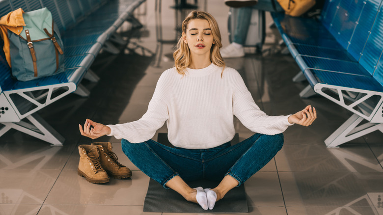 Girl meditating in airport