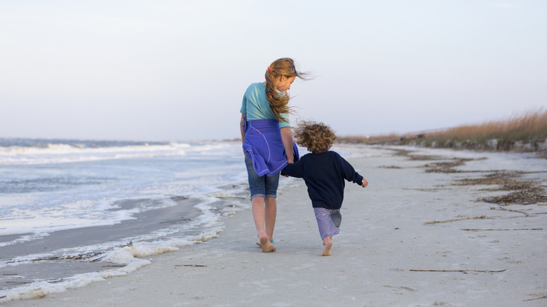 Two children walk on beach