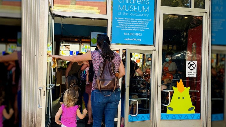 Mother and daughter open door