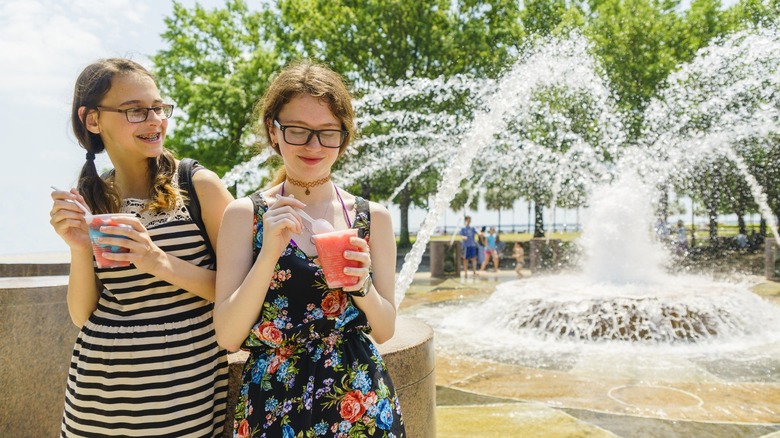 Two girls with water fountain