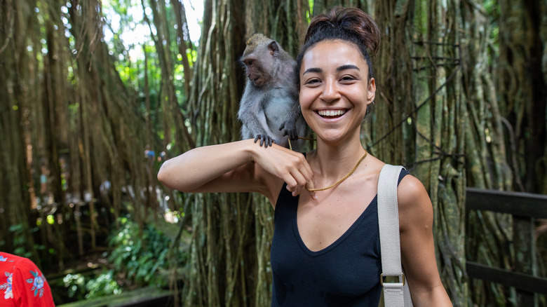 Tourist with monkey in Bali