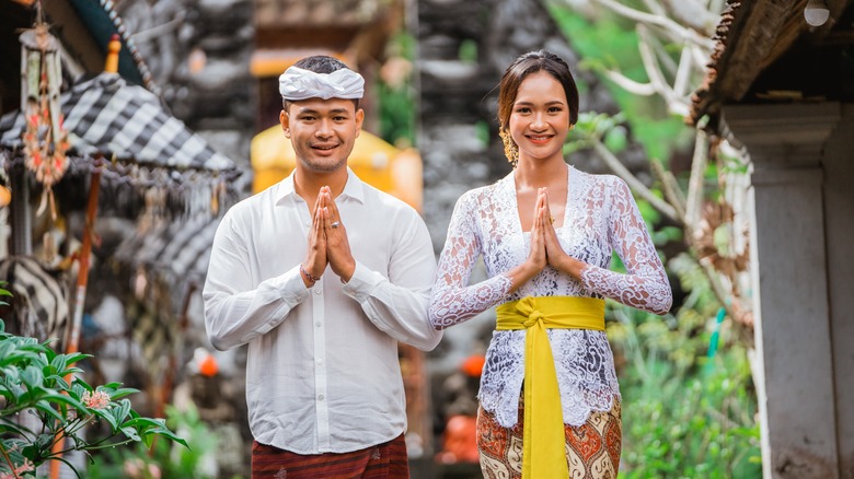 Couple in Bali greeting guests