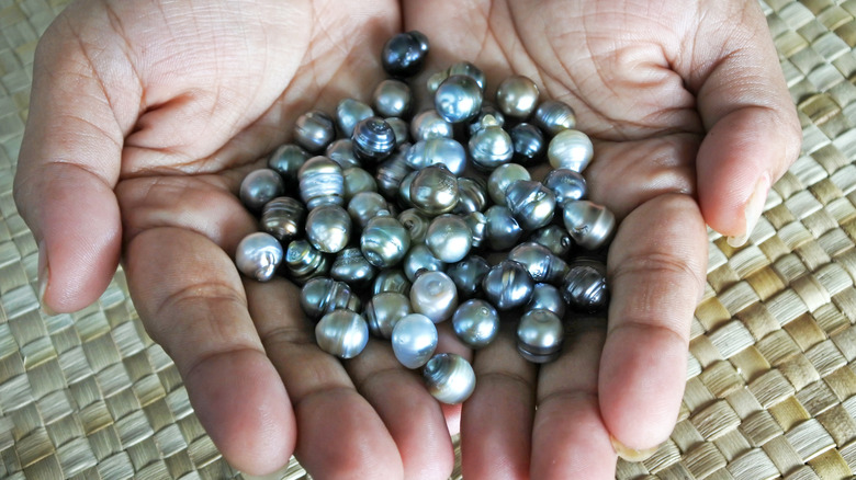 Fijian woman holding pearls
