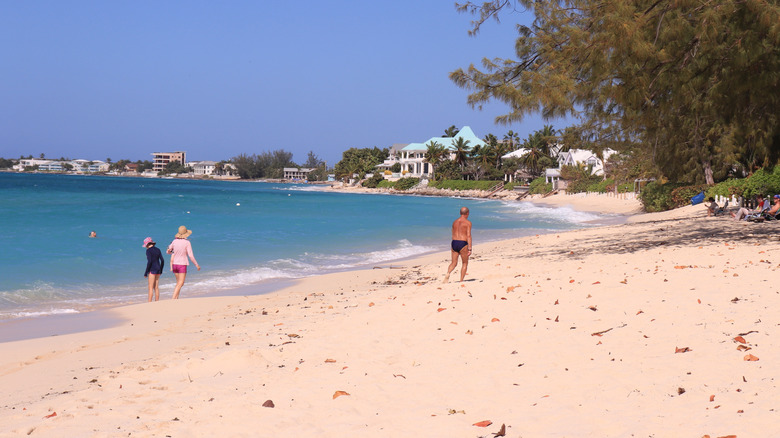 people walking on Seven Mile Beach