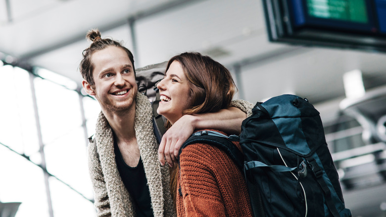 Couple laughing in airport