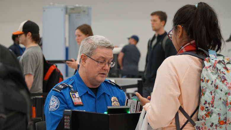 TSA checks a passenger's boarding pass and ID