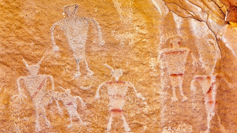 Petroglyphs carved into a rock wall