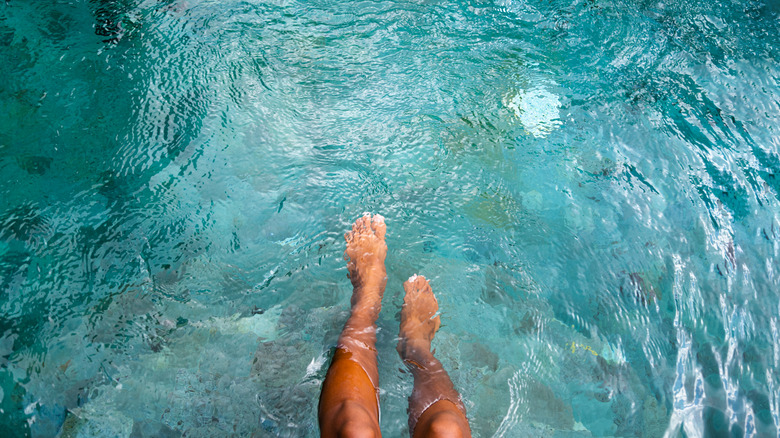 Feet in blue water