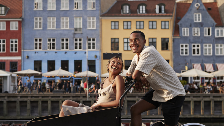 Couple smiling along European canal