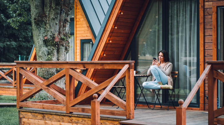 woman on vacation cabin porch