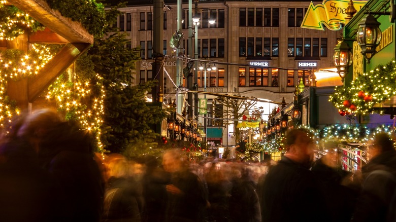 People exploring the Hamburger Weihnachtsmarkt in Rathausmarkt, a traditional Christmas market in Hamburg, northern Germany