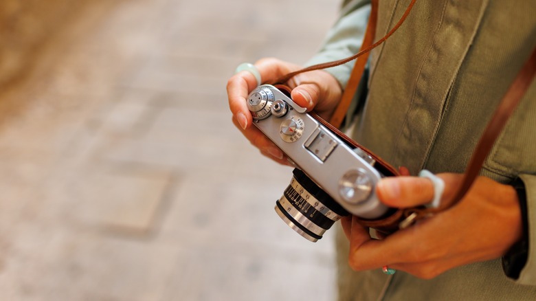 Person holding old film camera