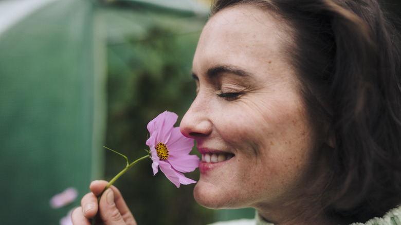 woman smelling flower