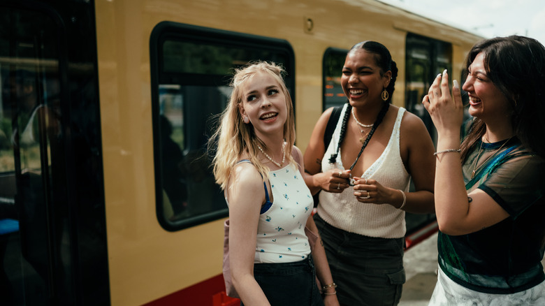 travelers hugging and smiling in street