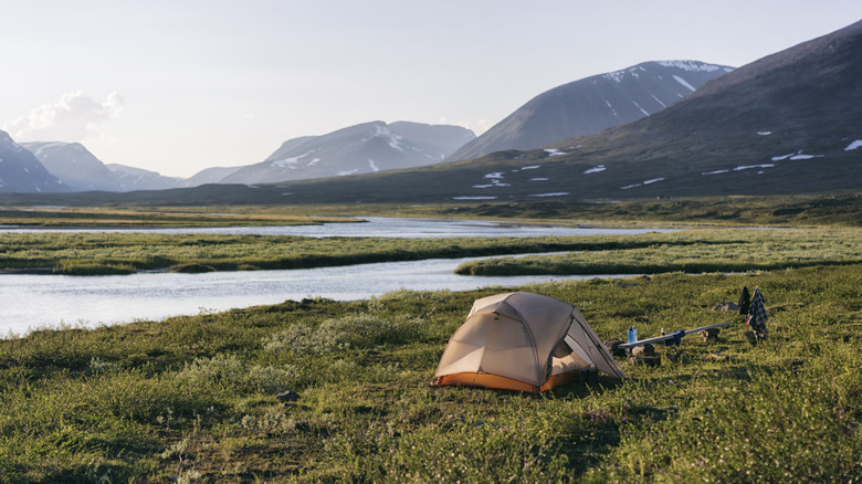 Tent by Swedish lake and mountains