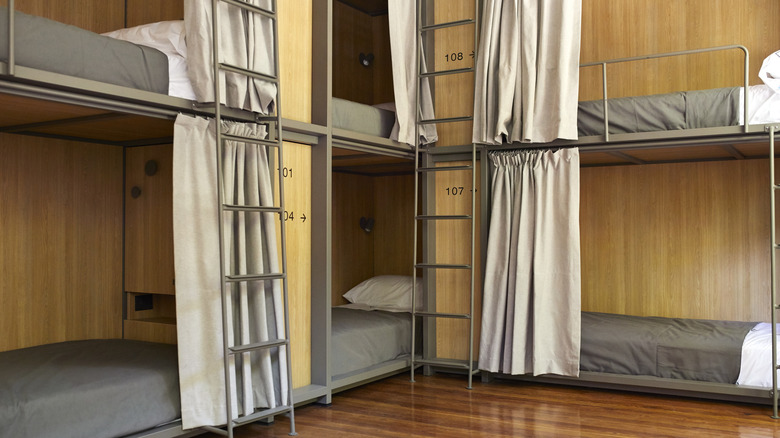 Youth hostel beds with privacy curtains