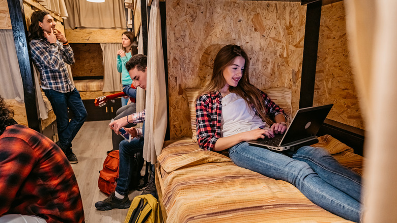 Young backpackers in hostel beds