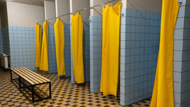 Hostel shower stalls with yellow curtains