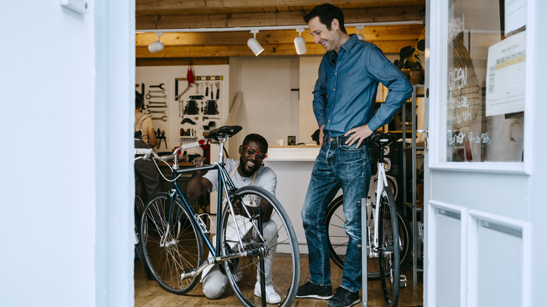 Man being assisted by bike shop mechanic