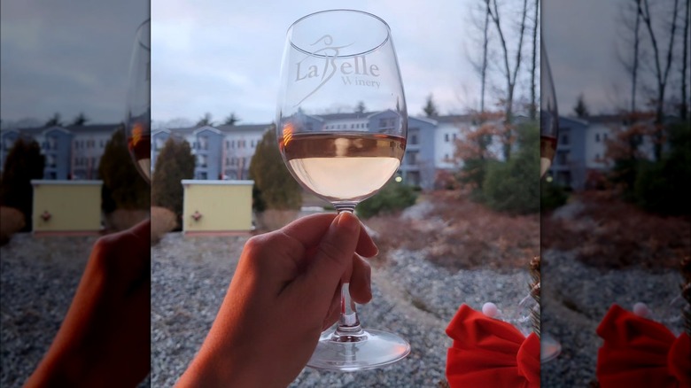 Person holding a glass of wine at La Belle Winery in Derry, New Hampshire