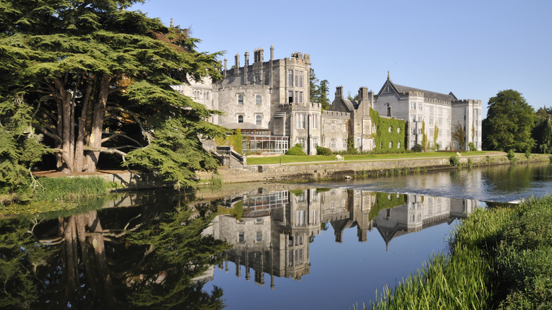 Adare Manor beside stream and trees