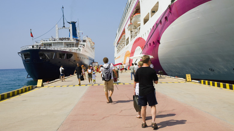 People getting on and off a cruise ship