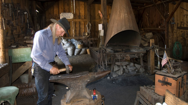 A blacksmith works in his shop at Columbia State Historic Park