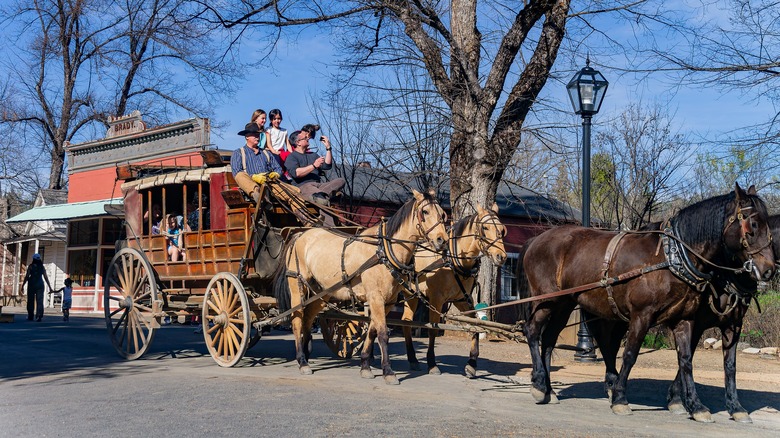 A family rides a stagecoach at Columbia State Historic Park