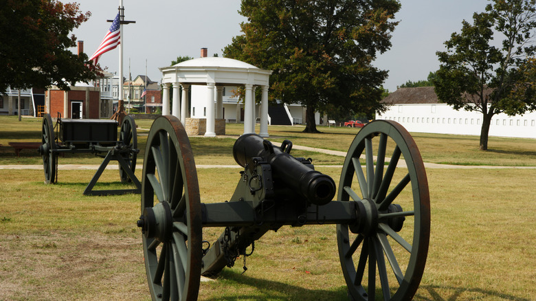 Old cannon and memorial buildings at Forst Scott National Historic Site in Kansas