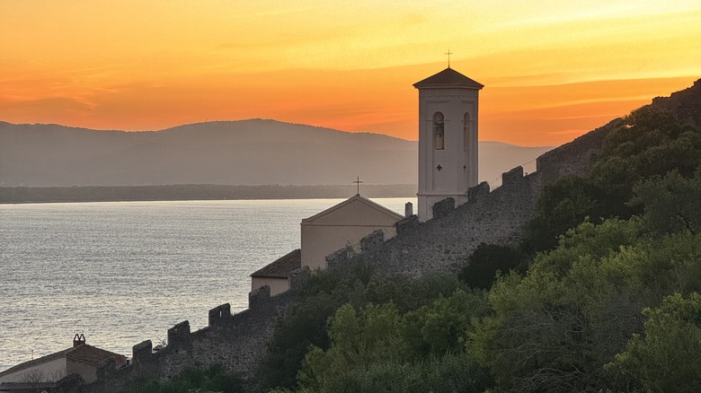 Sunrise over a grassy hilltop in Porto Ercole