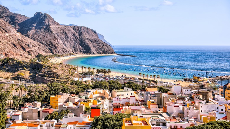 Coastal bay scene in Spain with mountains and buildings