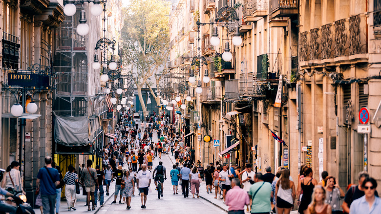 Crowded street scene amid old European buildings